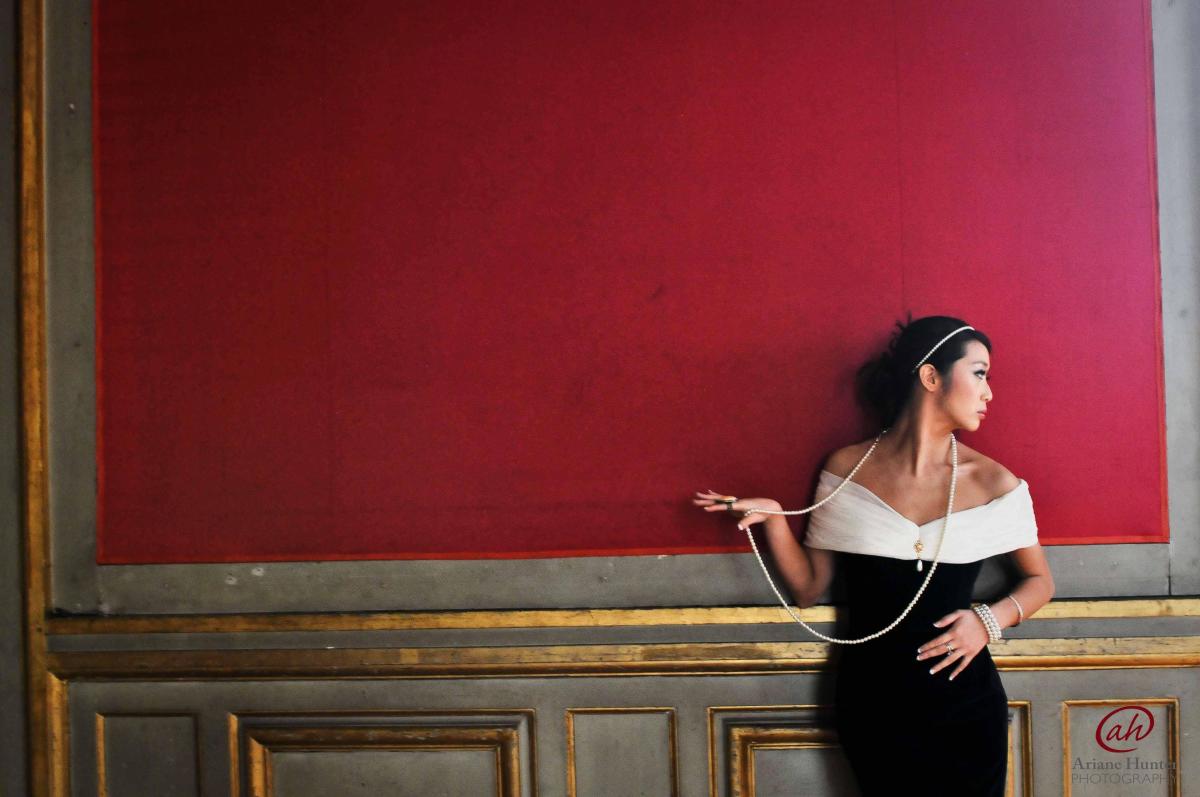 Woman standing against a red wall