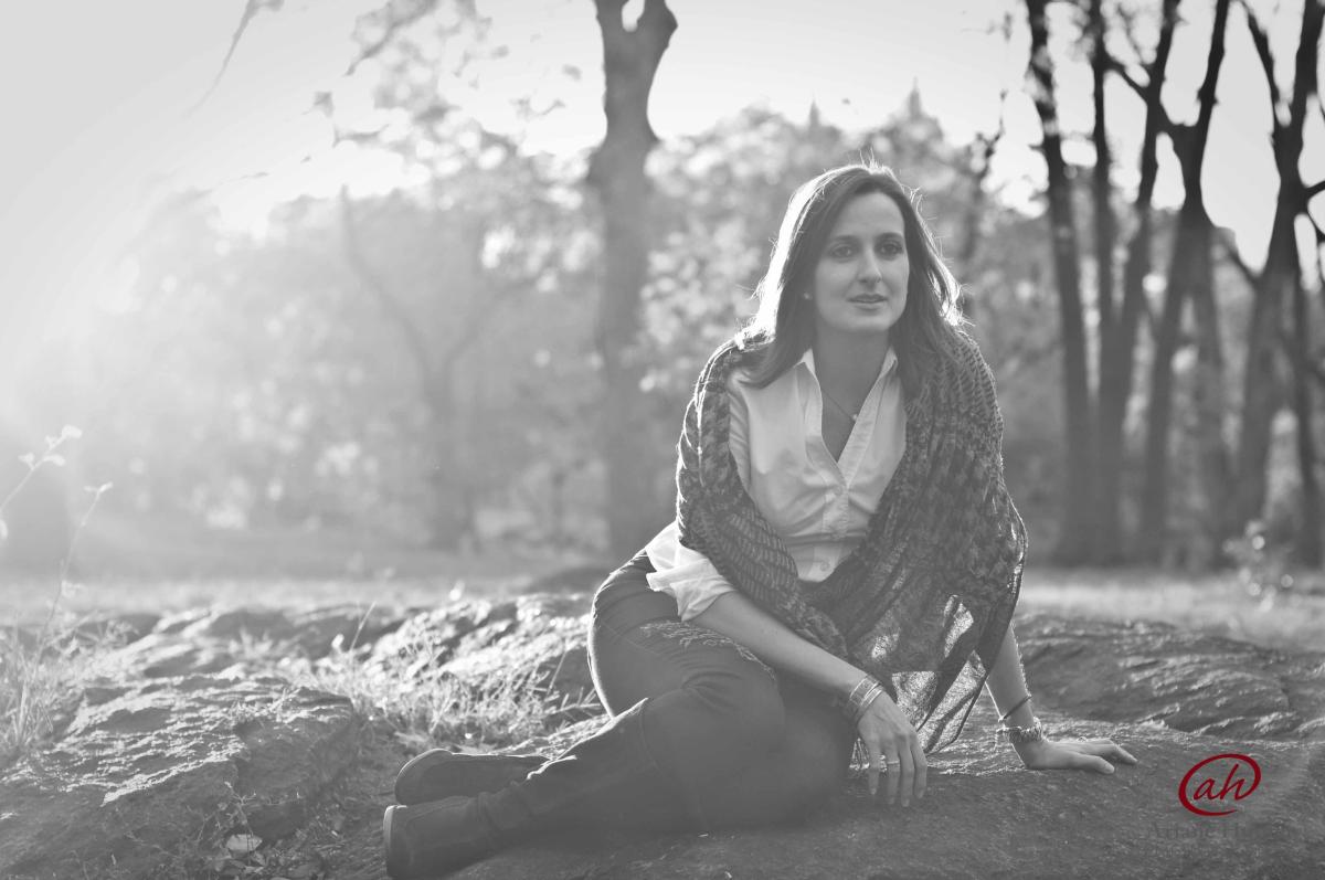 BW photo of a woman sitting on the ground