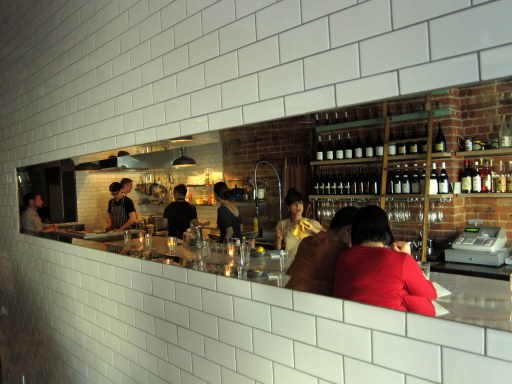 Shot of our backs in the mirror hanging across from the bar