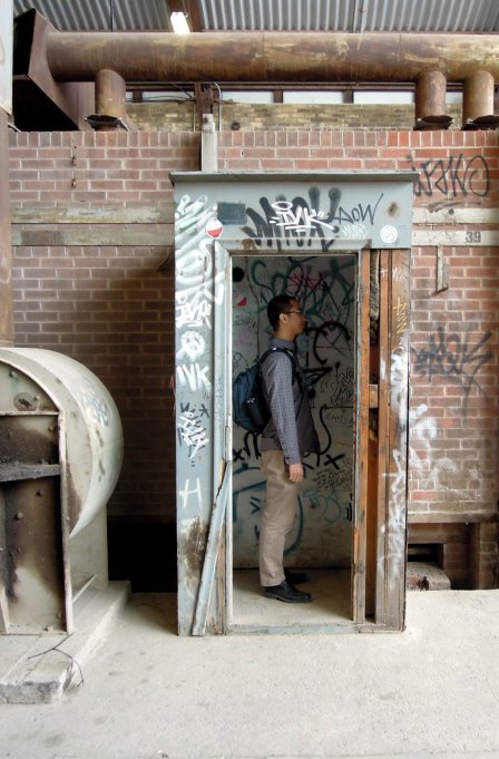 Erik inside an abandoned closetlike structure