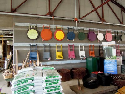 Folded outdoor chairs and tables hanging on a wall