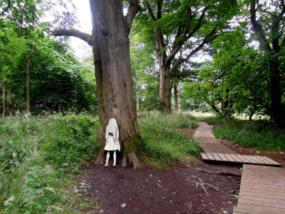 I was coming up on this one from what is the back of the path in this photo, and I turned my head toward the tree and saw the statue and she freaked me out. White statue of a weeping girl, leaning against a tree trunk