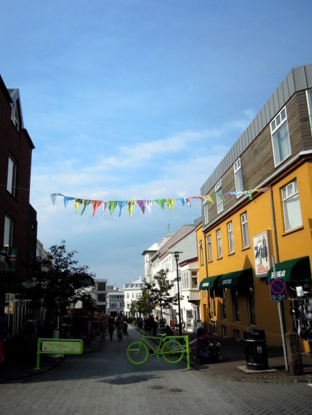 Green bicycle-shaped barricade on a pedestrian street