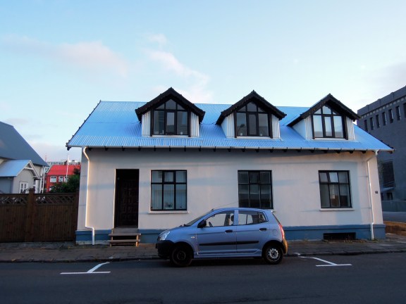 White house with blue roof and black trim