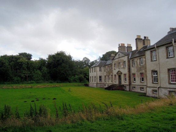 The back side of Newhailes with a lawn and path