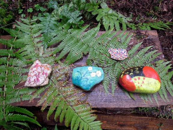 Painted rocks on ferns 