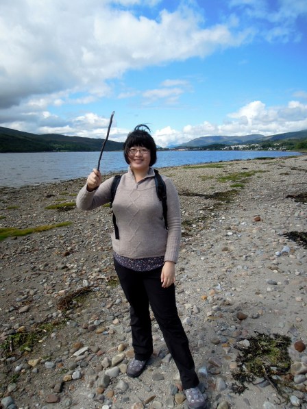 Lisa holding up a wand-like stick