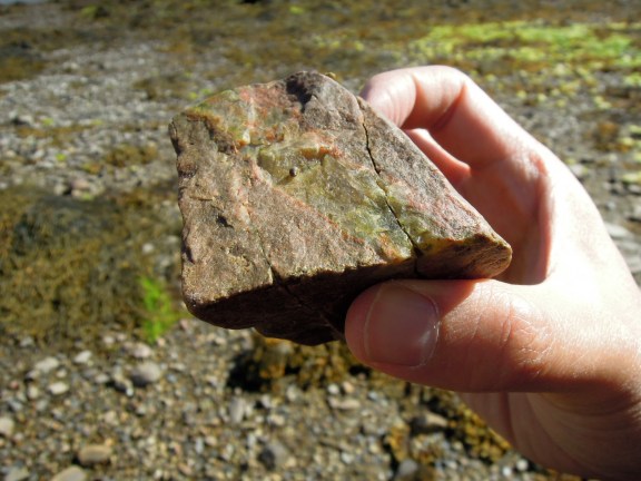 A multicolored rock held in Erik's hand