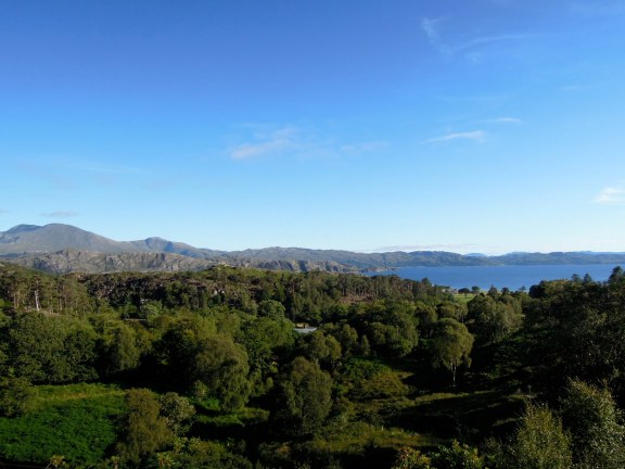 View over treetops View over treetops to the ocean with mountains