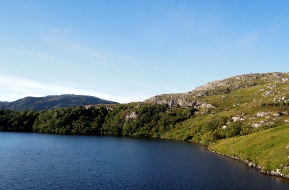 One of the many loch views from the train Water (loch?) with green hills around