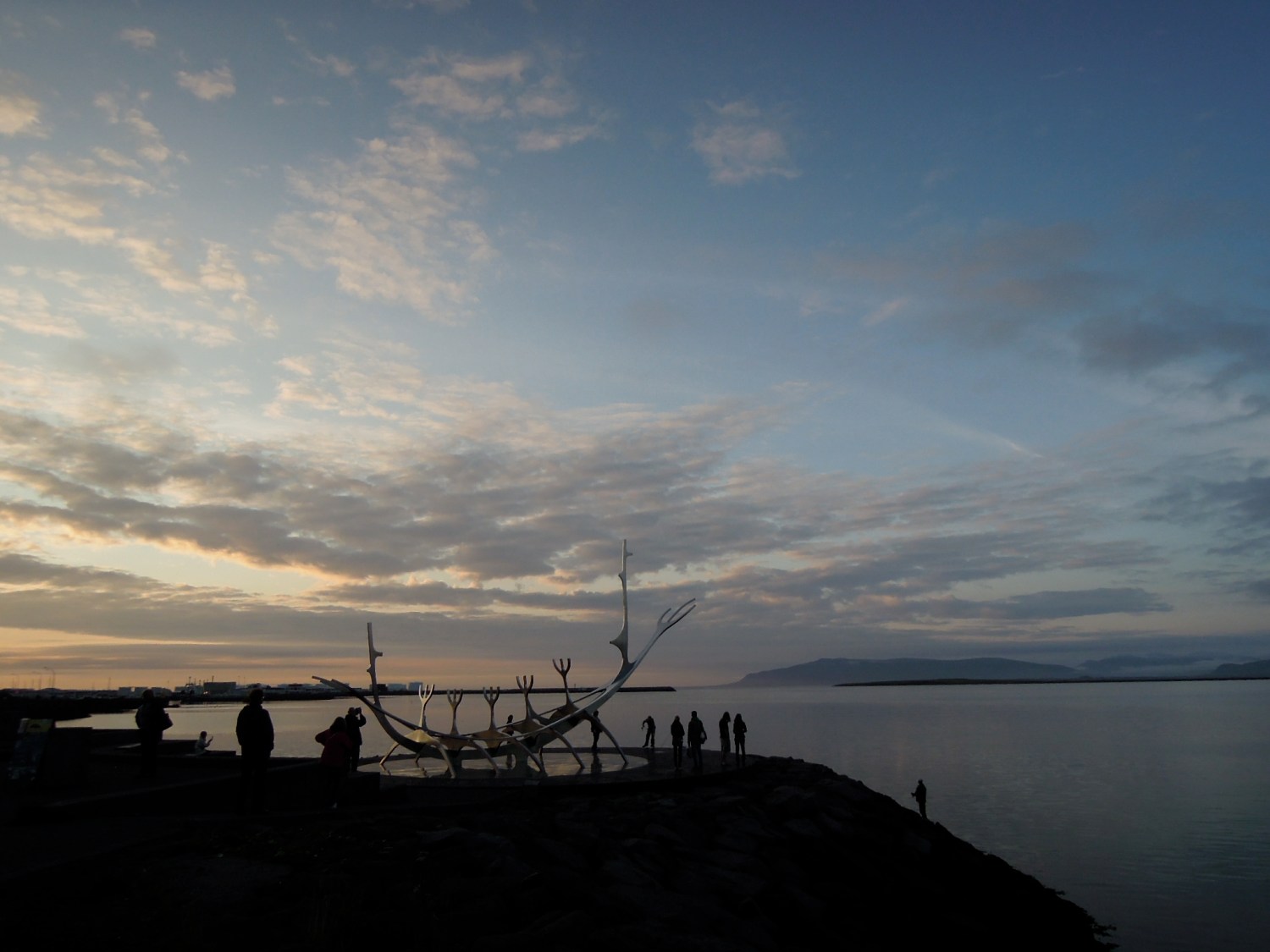 Modern sculpture of a ship, on the harbor at sunset