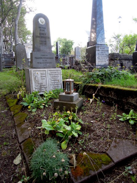 Little lantern next to a gravestone