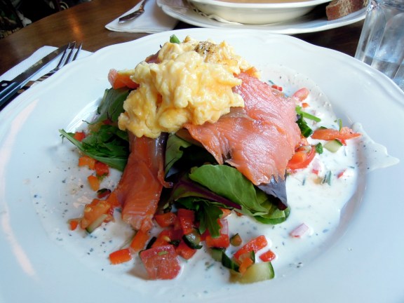 Smoked salmon and scrambled eggs and salad on toast