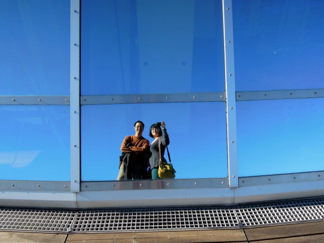 Double portrait in the reflective surface of the dome of Perlan