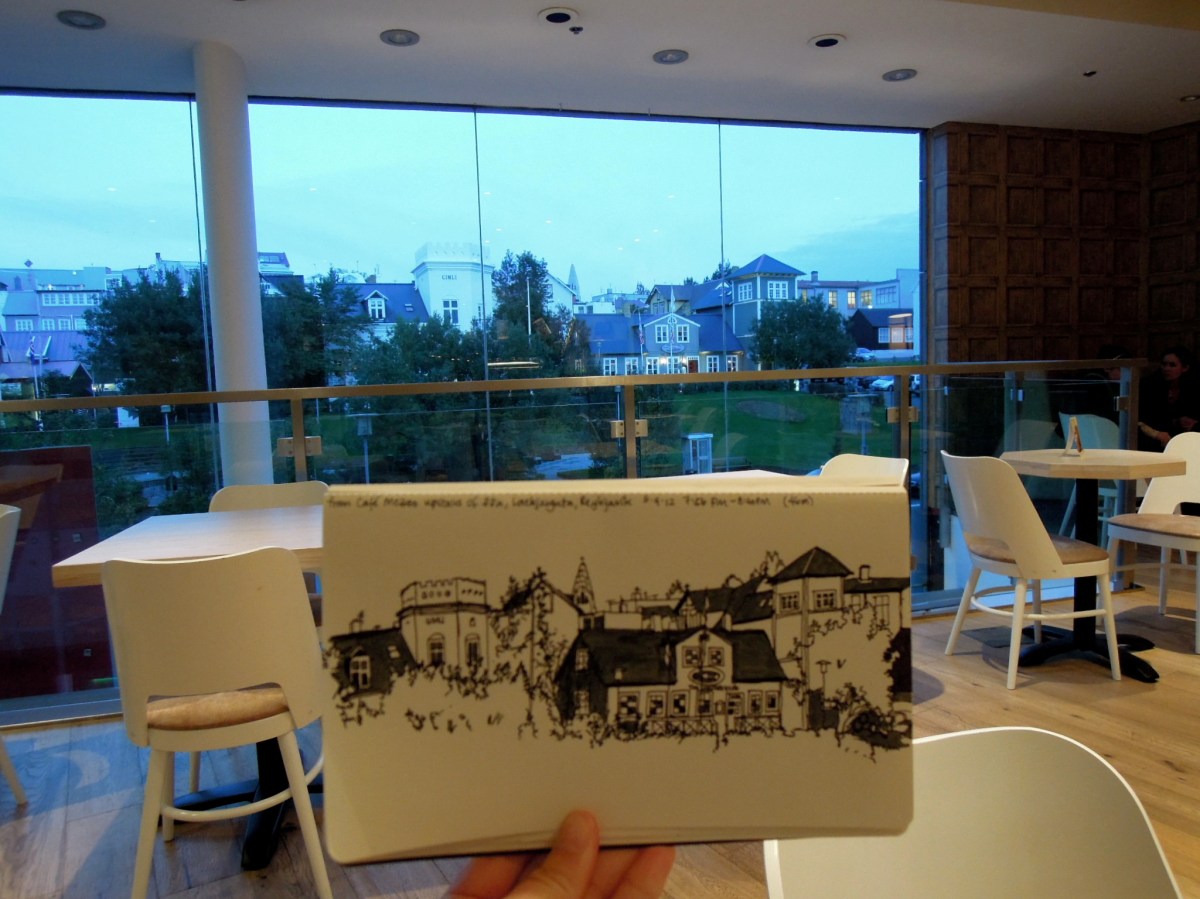 Holding up my sketch inside the cafe