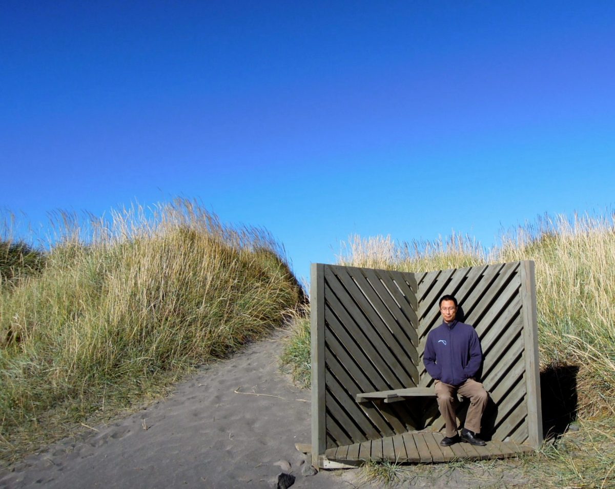 Erik sitting in some kind of wind shelter (?)