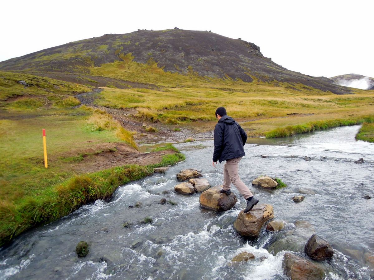 Erik crossing the river on rocks