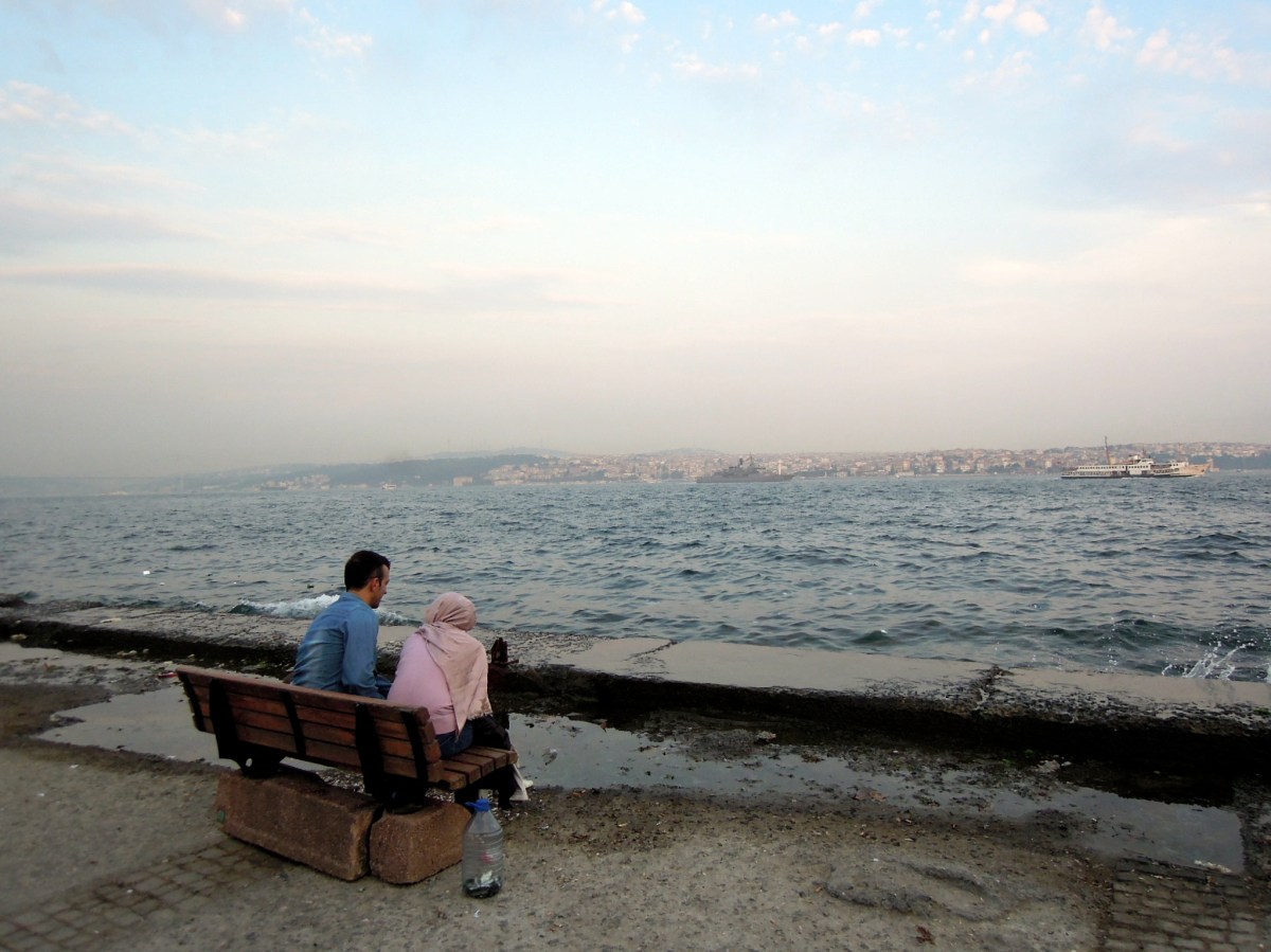 Couple sitting next to the water