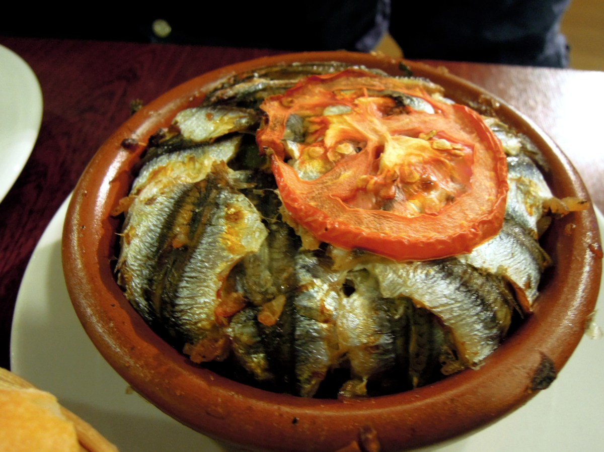 Fresh anchovy pilaf in a terracotta ramekin