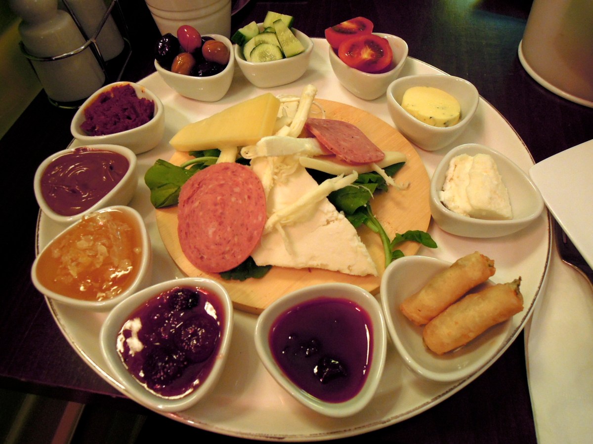 Yımırta breakfast plate with cheeses, salami, arugula (rocket), cucumbers, tomatoes, olives, and spreads
