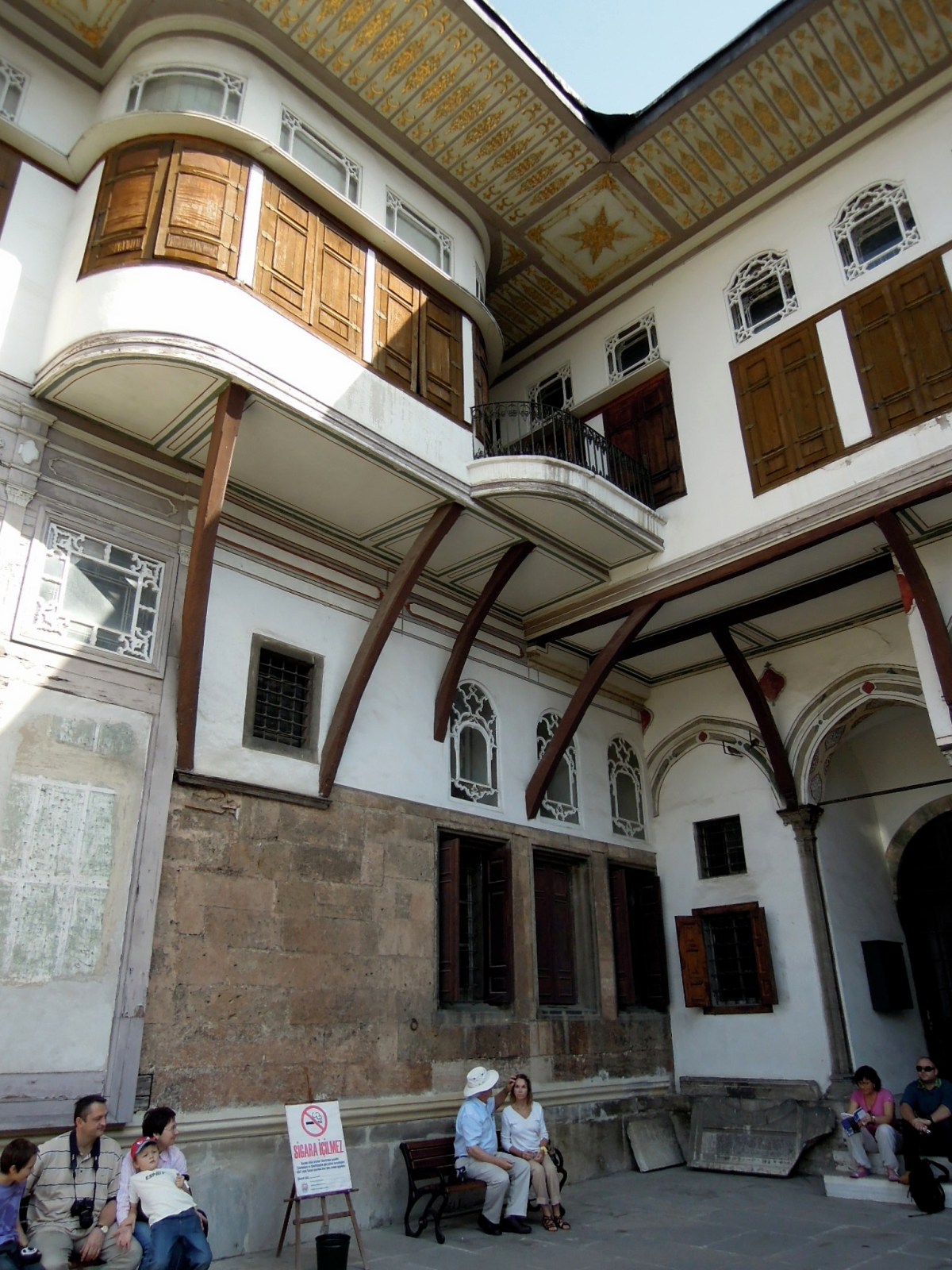 Tourists sitting on benches in the Favorites' Courtyard