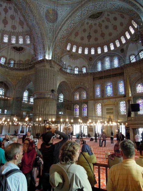 Tourists and the prayer area inside the Blue Mosque