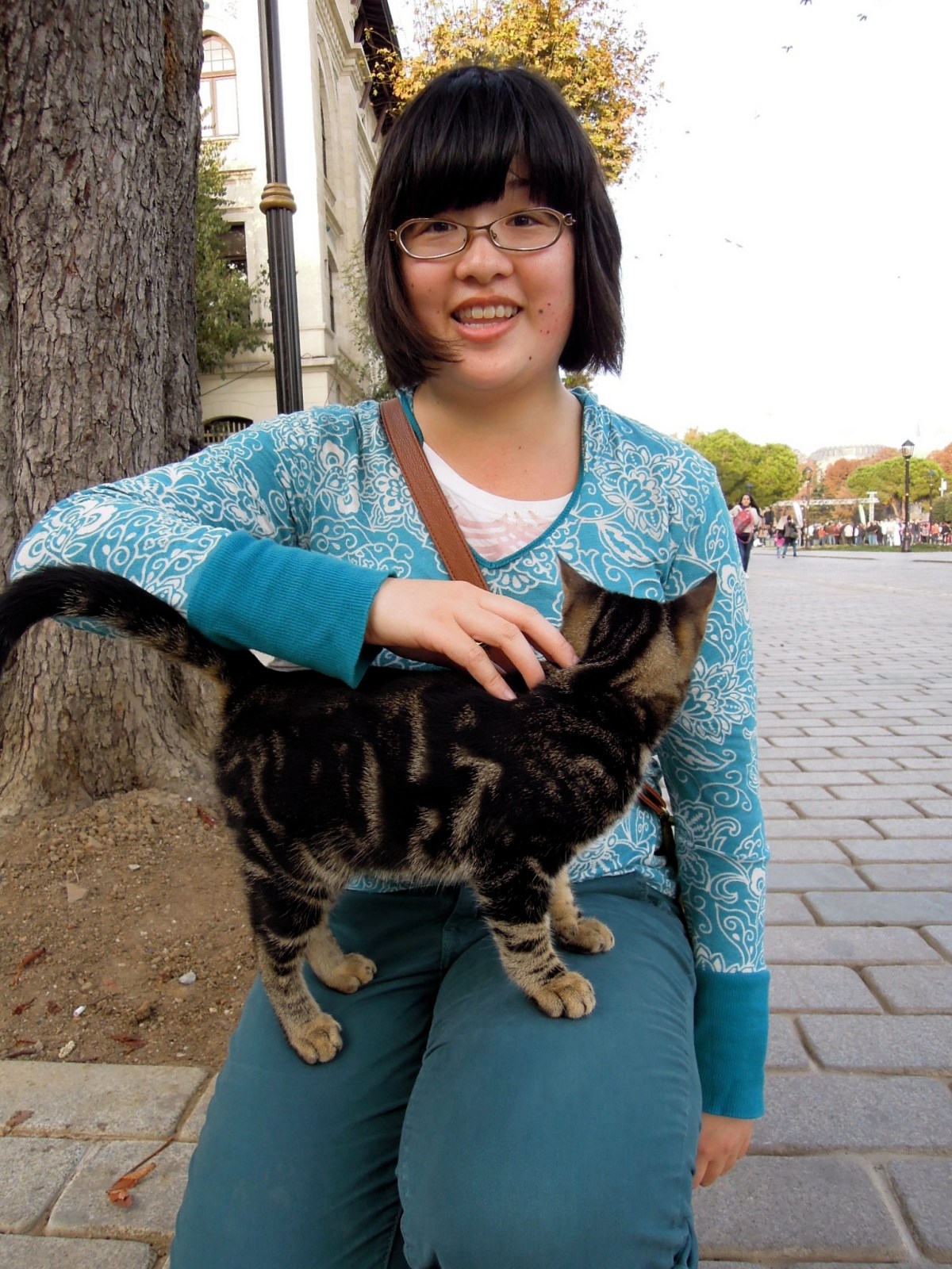 Lisa happily petting a kitty