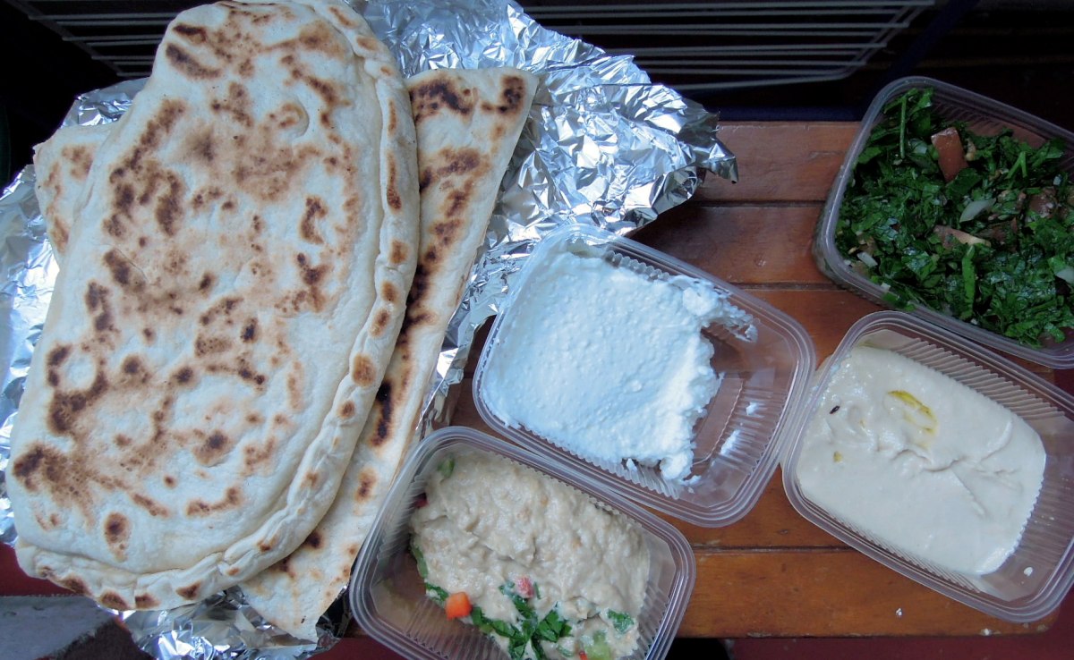 Lebanese lunch: filled flatbreads, hummus, eggplant dip, tabbouleh, garlic cream