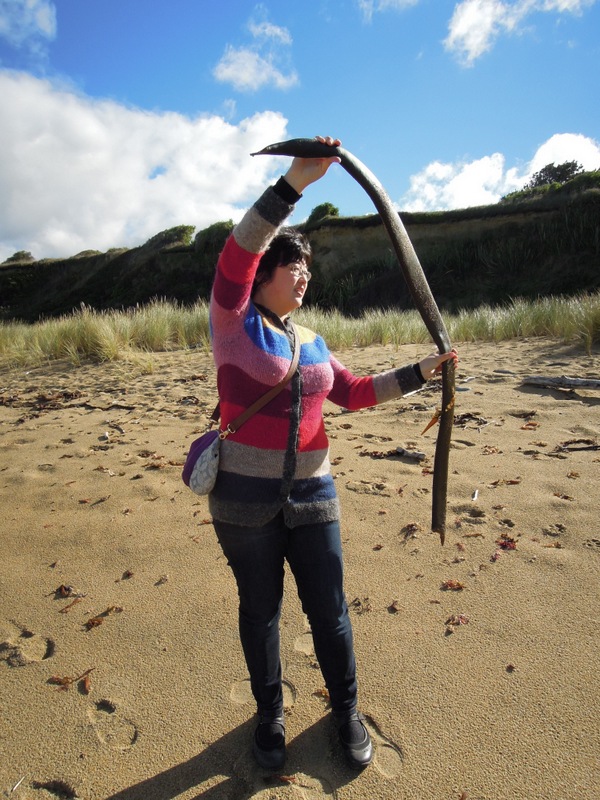 Lisa playing with a big piece of kelp (?) in New Zealand