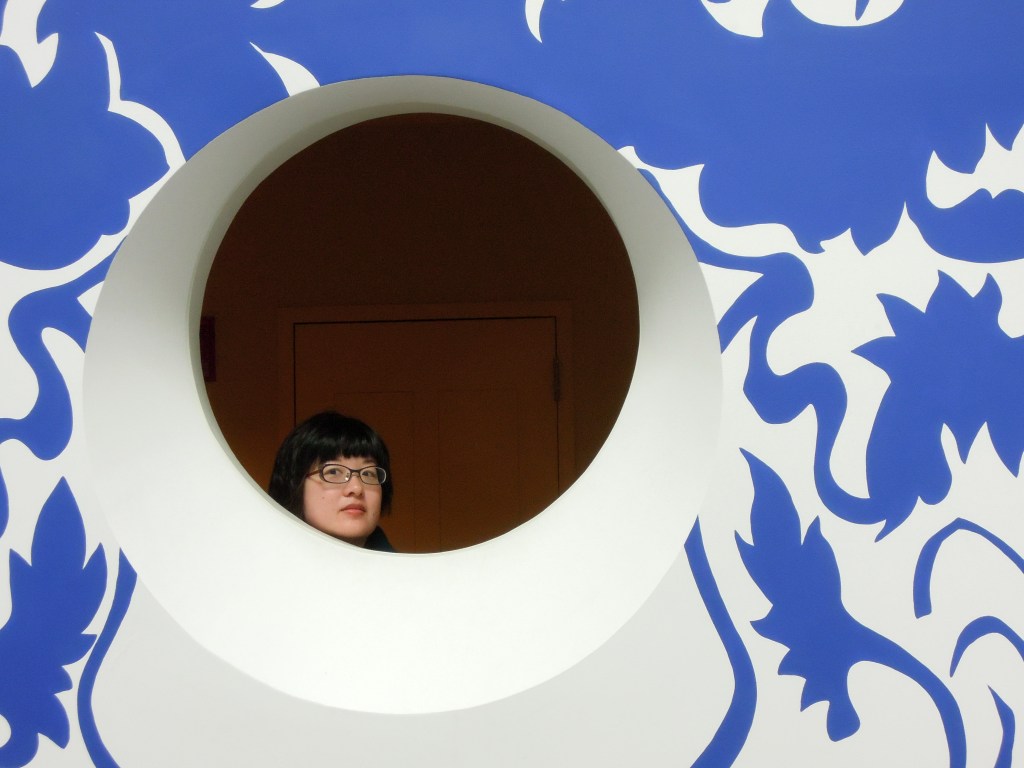 Lisa looking through a circular window