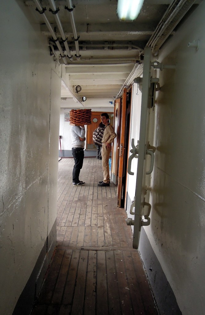Simit seller holding his stacked breads, Istanbul ferry