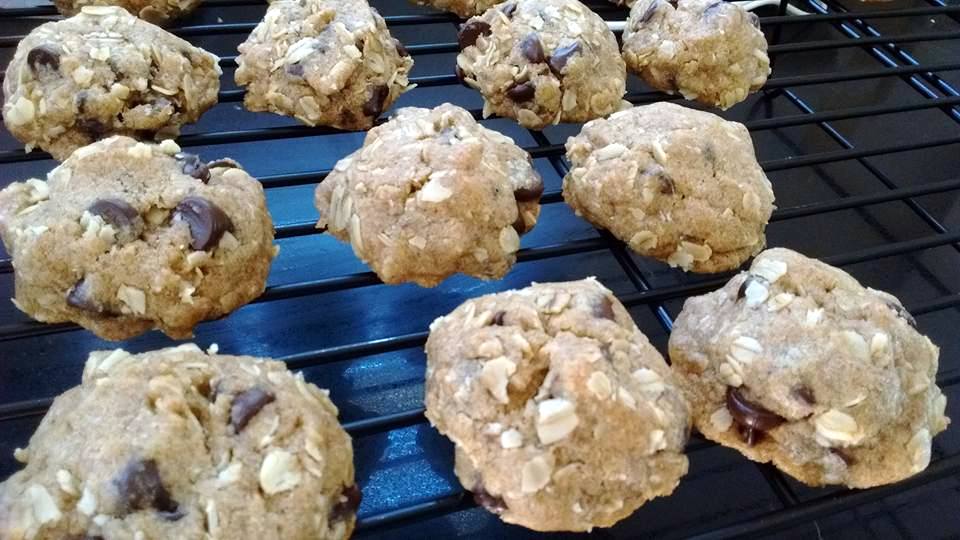 Whole wheat oatmeal chocolate chip cookies cooling on a rack