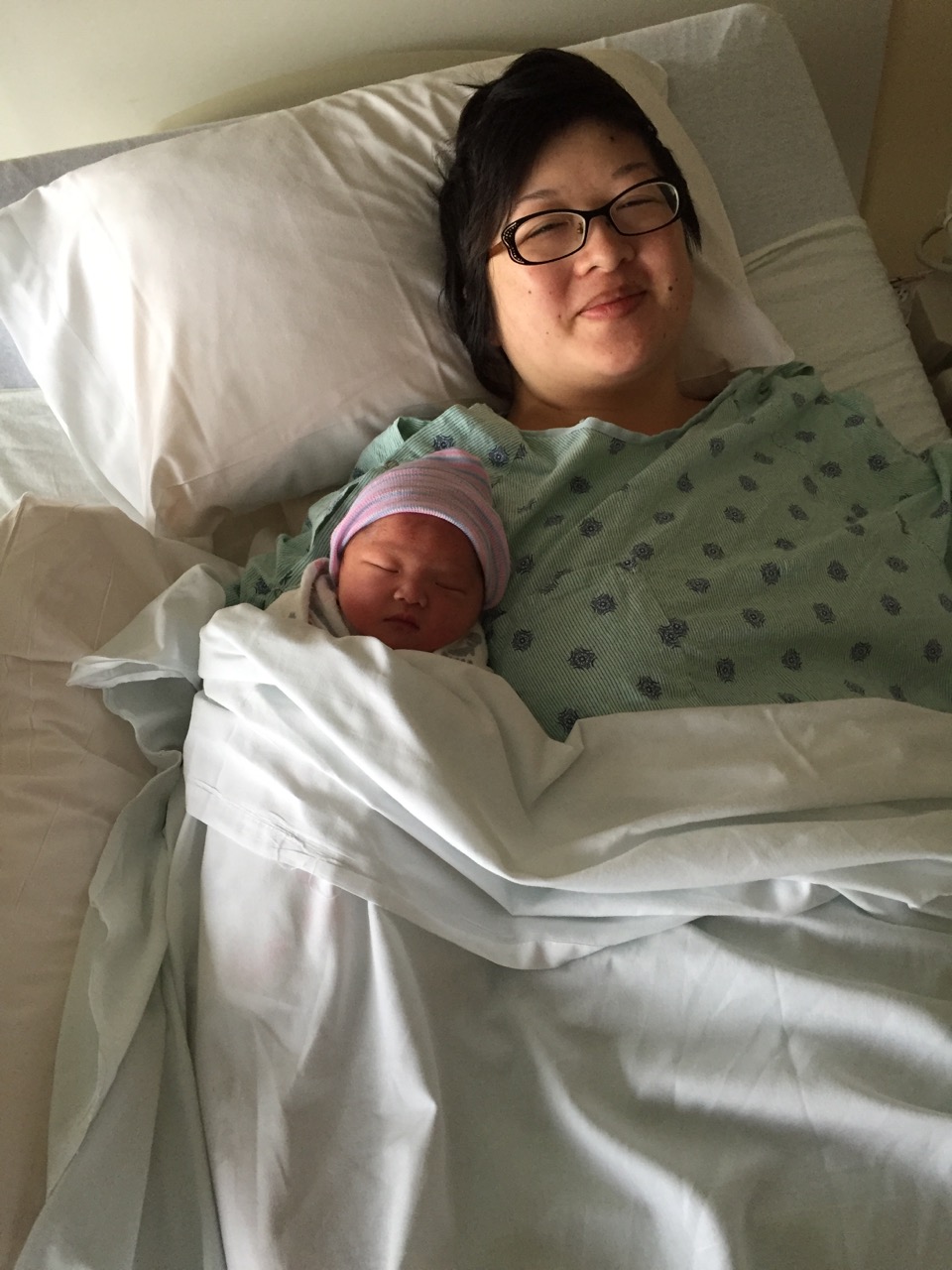 New mama in bed with new baby