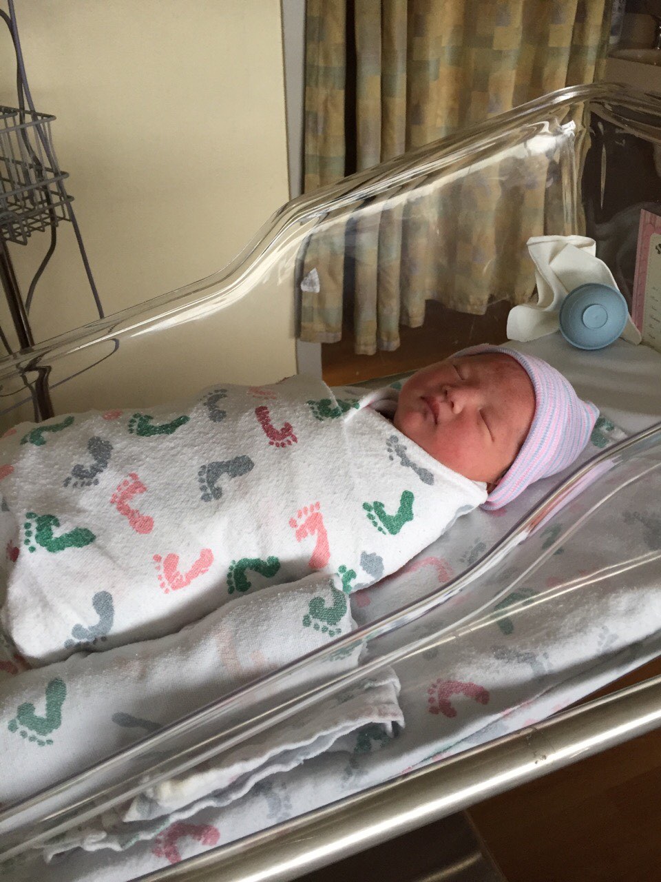 Newborn in hospital bassinet