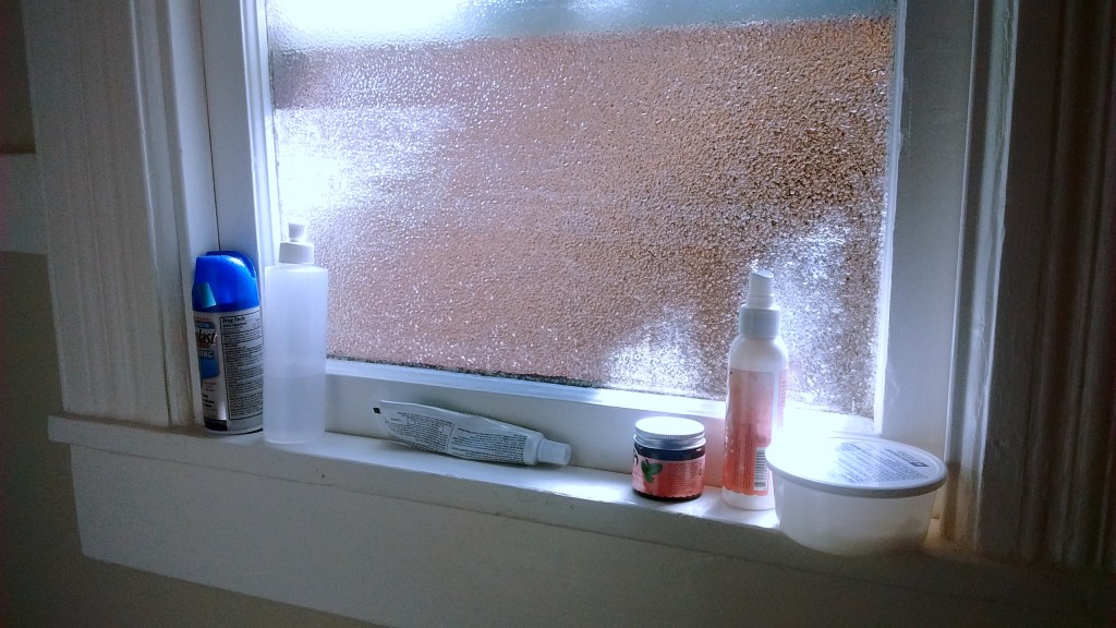 Bathroom window with various ointments and sprays