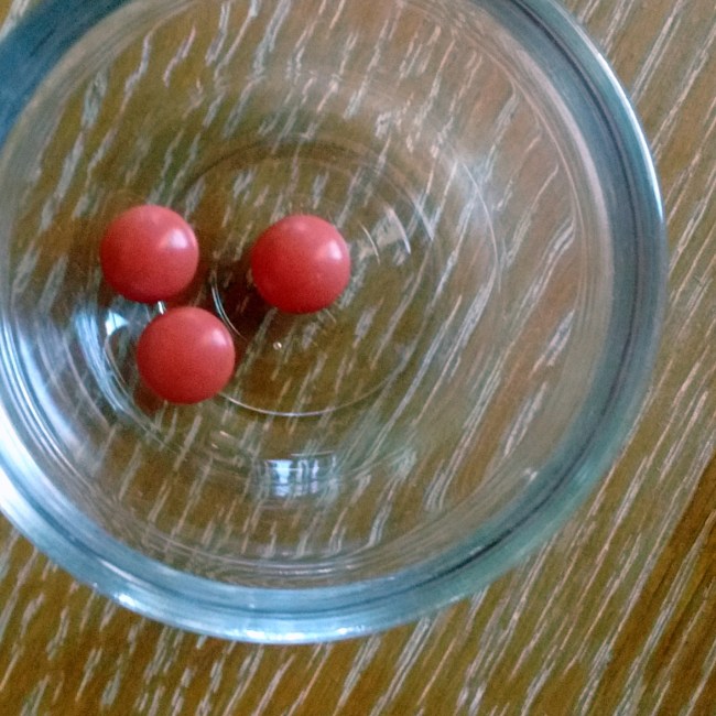 three Advil in a glass bowl