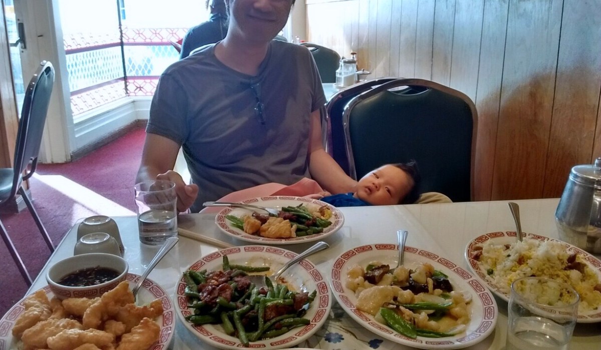 Erik holds two-month-old Ada while we have dinner at a Chinese restaurant