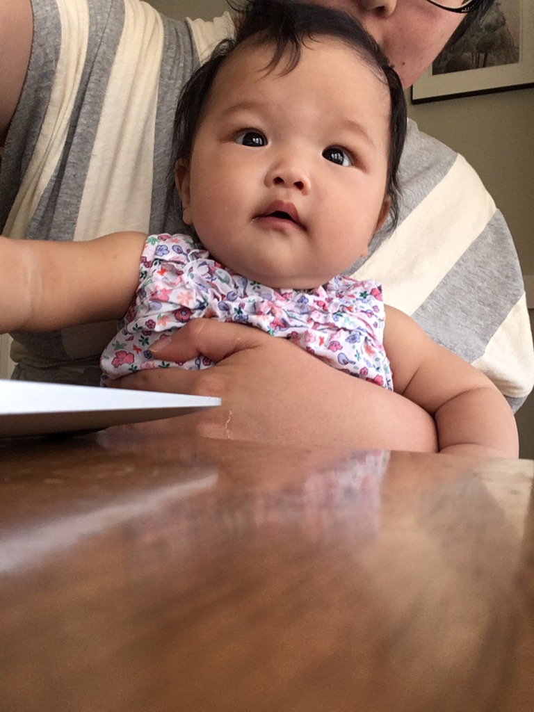 baby Ada being held sitting up