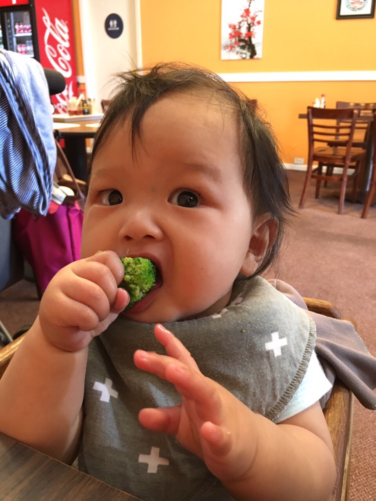 baby Ada eating broccoli