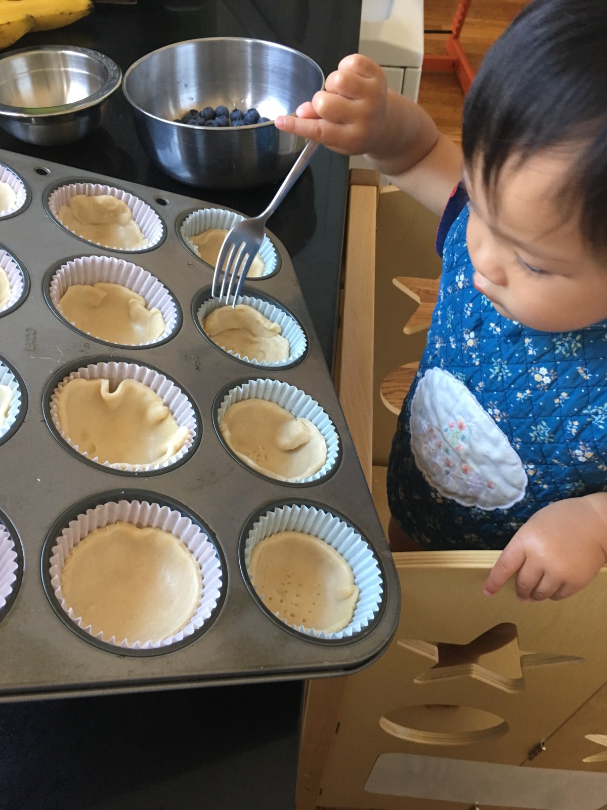 16-month-old Ada pricks pastry dough with a fork