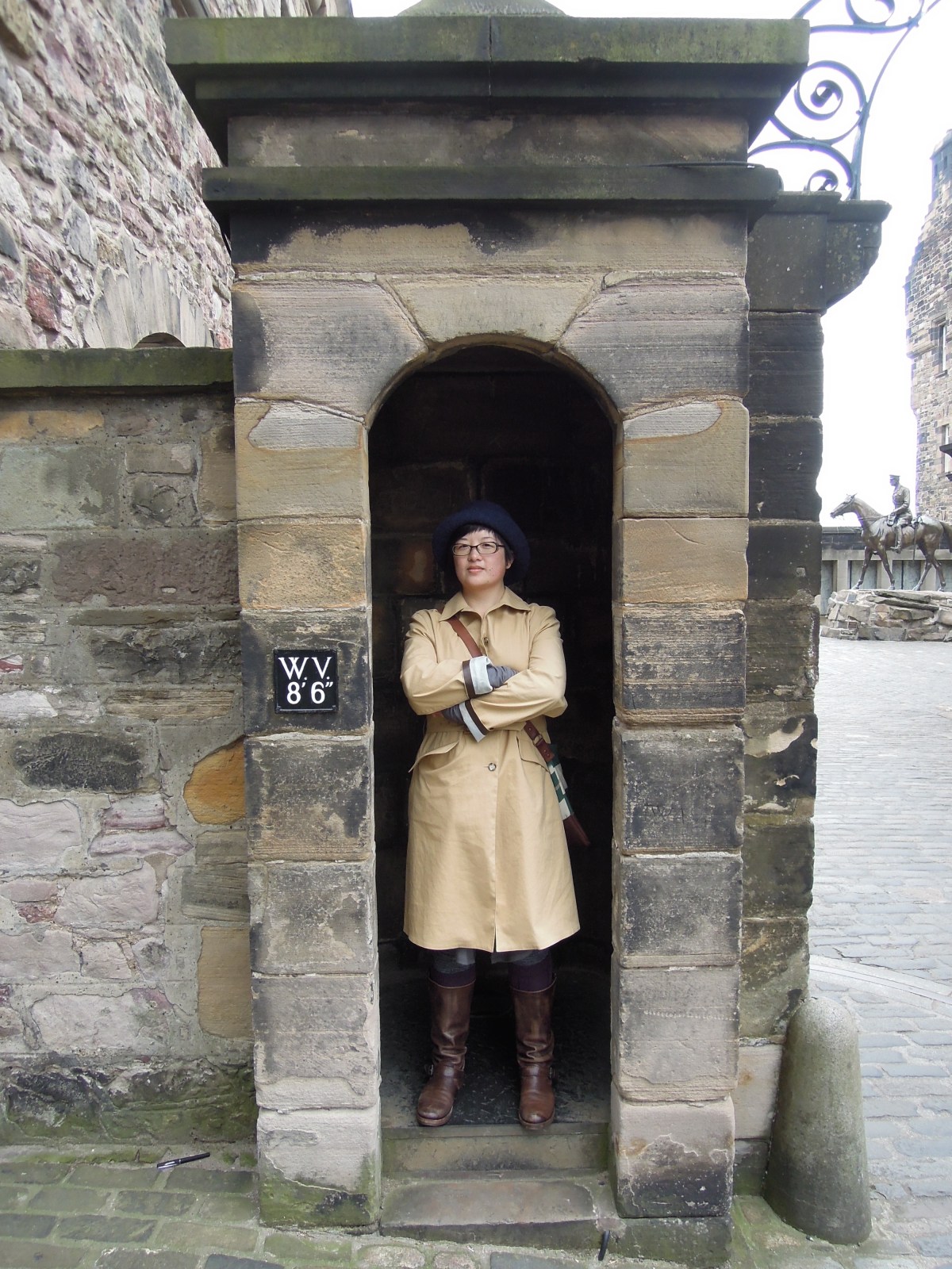 Lisa standing with arms crossed in a guard booth at Edinburgh Castle