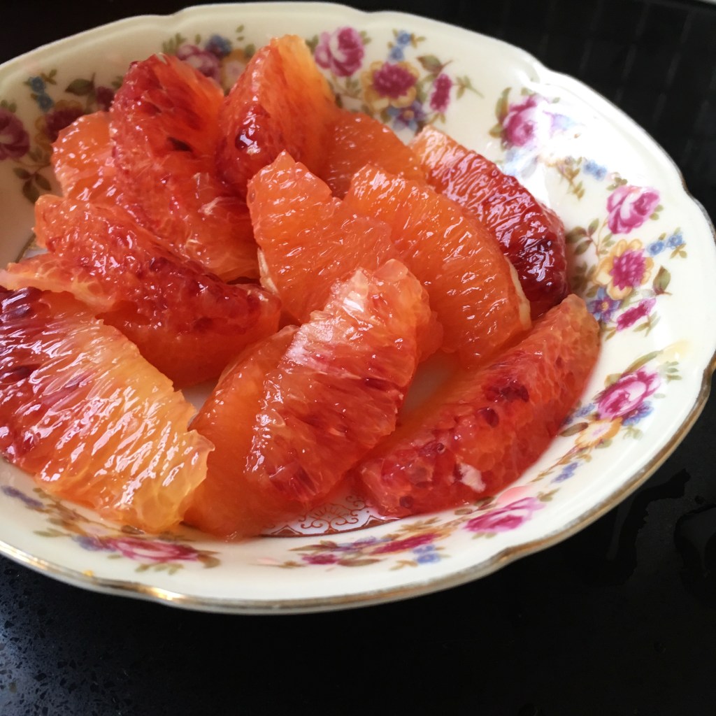 Blood orange and Cara Cara orange supremes in rose-patterned dish