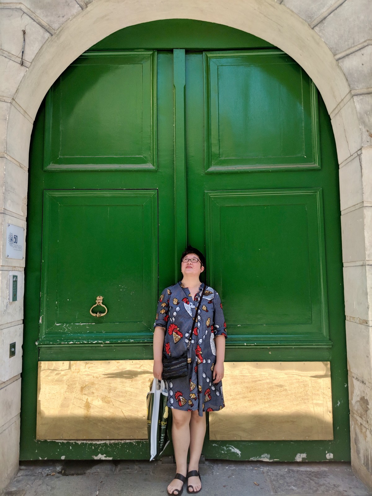 Lisa in front of an arched green door, Paris