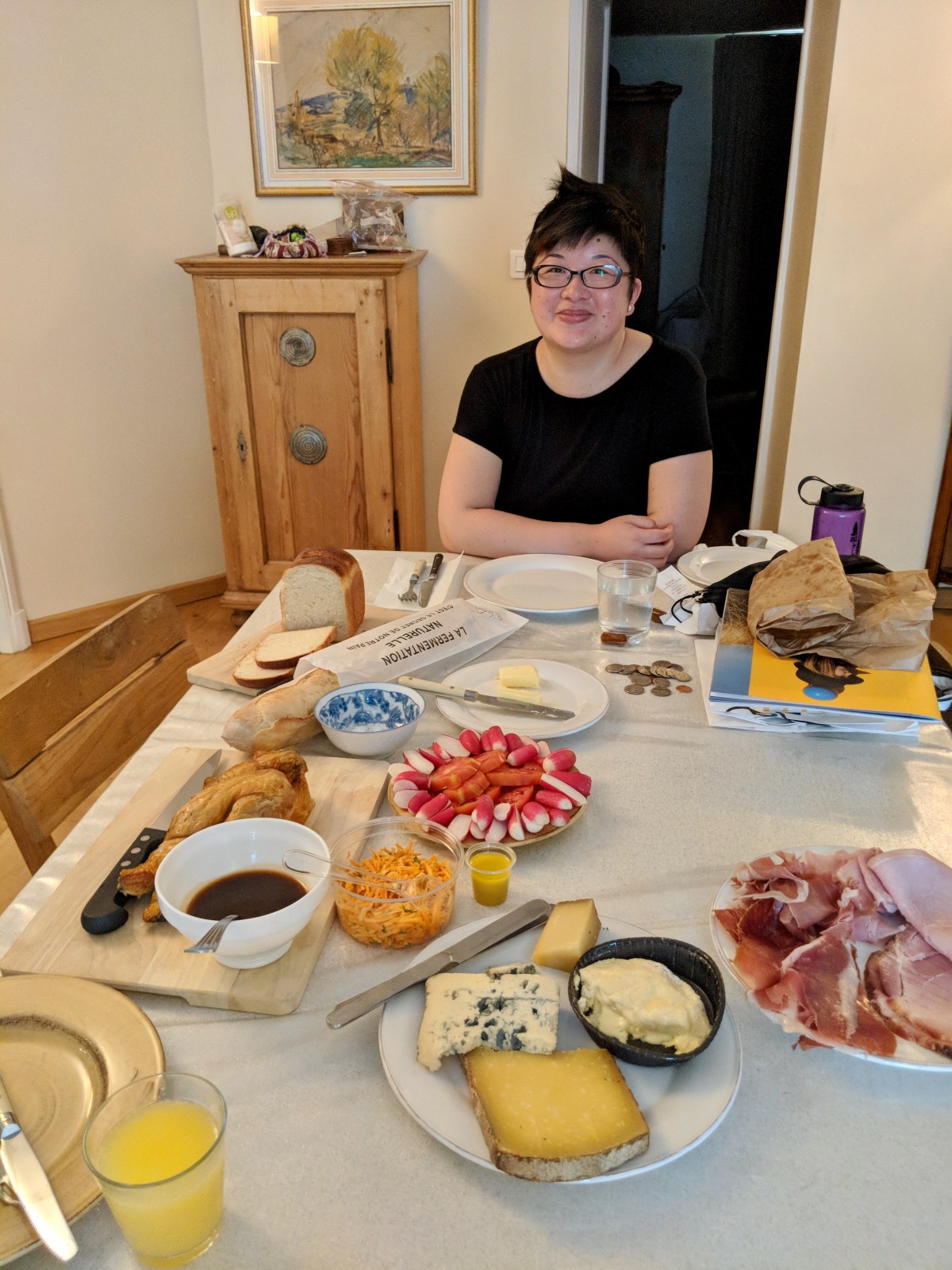 Lisa surrounded by cheese, ham, and other dinner items