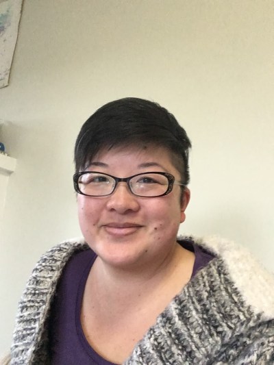 38-year-old Chinese American woman with short hair and glasses