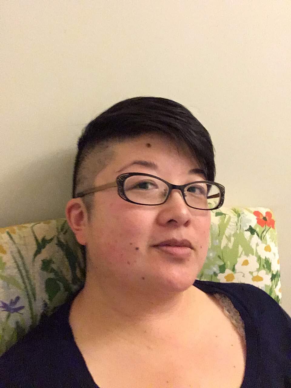 38yo Asian American person with short hair, shaved sides, and black-framed glasses