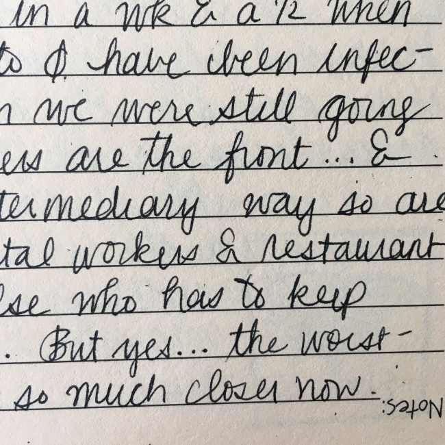 Cursive in black ink on pale tan lined paper