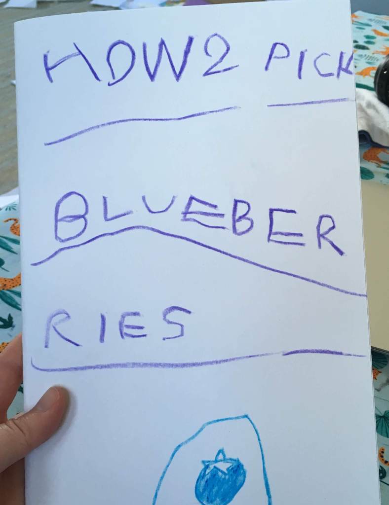 A child's crayon writing, "HOW2 PICK BLUEBER RIES" 