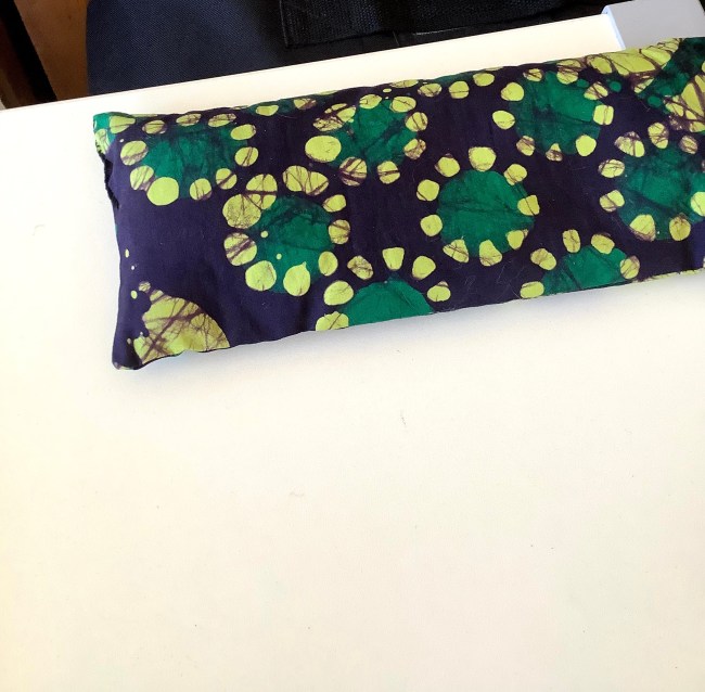 Dark blue eye pillow with wax print of dark and lighter green circles